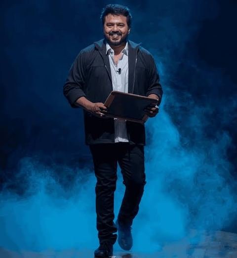 Mentalist Aathi walking on stage through blue smoke